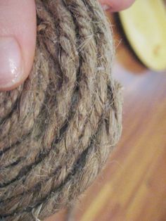 a person holding a ball of yarn in their left hand and the end of it