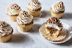 several cupcakes with white frosting and cinnamon sprinkles