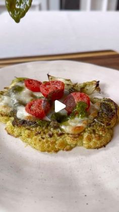 a white plate topped with food on top of a wooden table