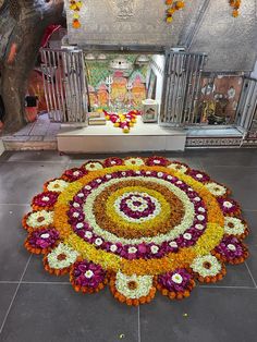 a large flower arrangement on the ground in front of a shrine