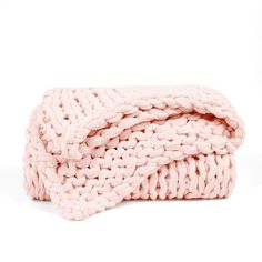 a pink knitted blanket on a white background