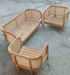 three wooden benches sitting next to each other on the cement floor in front of a building