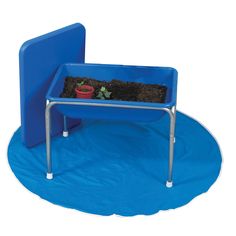 a blue potted planter sitting on top of a blue mat next to a chair