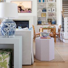 a living room filled with furniture and a fire place in front of a white fireplace