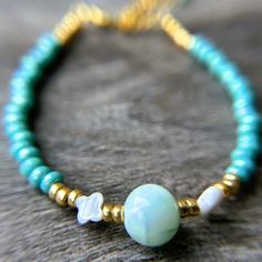 Bring the beauty of the beach to your wrist with this exquisite shell and glass bead bracelet! This handmade bracelet features delicate natural shells paired with shimmering turquoise Czech glass beads, creating a perfect blend of natural and elegant elements. Inspired by the calming colors and textures of the ocean, this bracelet is ideal for those who love coastal style or want a reminder of their favorite seaside escapes :) FEATURES: - Handmade with real shells and premium Czech glass beads - Dainty Turquoise Bracelets For Beach, Dainty Turquoise Bracelet For Beach, Dainty Adjustable Pearl Bracelet For Beach, Dainty Turquoise Beaded Bracelets For Beach, Hawaiian Bracelets, Beach Wedding Jewelry, Island Jewelry, Glass Bead Bracelet, Bridesmaid Gifts Jewelry