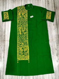 a green shirt with yellow designs on it