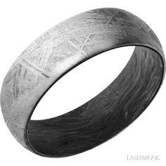 a black and white photo of a wedding ring with an etched pattern on the inside