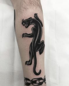 a black panther tattoo on the arm