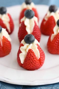 strawberries with white frosting and blueberries on top