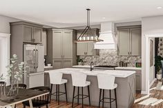 a large kitchen with wooden floors and gray cabinets