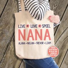 a woman is holding a tote bag with the words live love spell nana on it