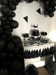 a party table with black and white decorations