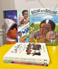 three children's books sitting on top of a yellow table next to each other