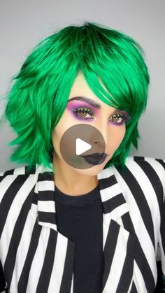 a woman with green hair and black and white striped shirt