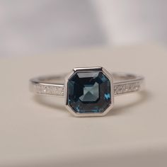 All HANDMADE ITEMS SHIP IN APPROX 8 DAYS Main Stone: Genuine London blue topaz Main Stone Size: Asscher cut 7 mm x 7 mm Main Stone Weight: 2.25 carat Side Stone: ,CZ Height From The Ring Setting Bottom(to gemstone top): about 5.78 mm Width of Ring band Measure: gradually varied,about 2.26 to 2.30 mm Material: 925 Sterling Silver/14K White Gold/14K Yellow Gold/14k Rose Gold Engraved: Available For FreeNo more than 13 letters) Customized:Of course! Tell me what you want Includes With Order: All of Octagon Sapphire Ring For Anniversary, Octagon Sapphire Ring Birthstone For Anniversary, Octagon Sapphire Birthstone Ring For Anniversary, Blue Topaz Ring With Emerald Cut And Bezel Setting, Asscher Cut Sapphire Ring With Bezel Setting, Octagonal Topaz Ring For Anniversary, Fine Jewelry Asscher Cut Topaz Ring For Anniversary, Emerald Cut Topaz Ring With Bezel Setting As Gift, Aquamarine Bezel Set Ring For Anniversary