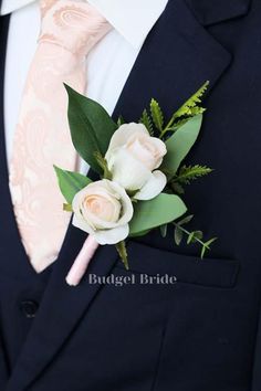 a man wearing a suit and tie with flowers on it's lapel flower