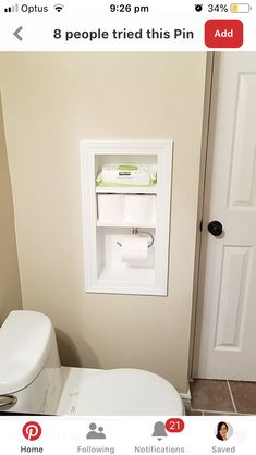 a white toilet sitting in a bathroom next to a wall mounted paper dispenser