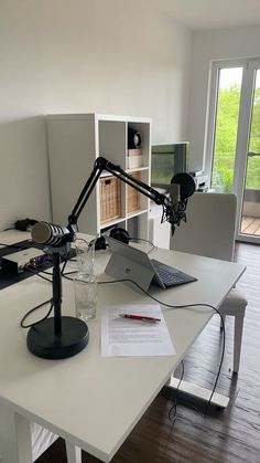 a desk with a laptop and lamp on it