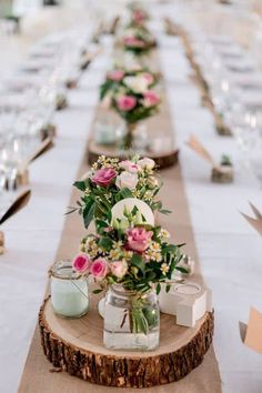 a long table with flowers and candles on it