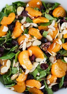 a salad with oranges, almonds and spinach