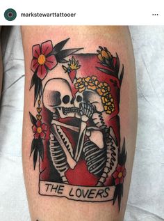 a tattoo on the leg of a man with a skull and flowers in his hair