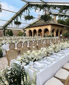 tables set up with white flowers and greenery for an outdoor wedding reception at the resort