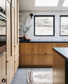 the kitchen is clean and ready for us to use it's natural wood cabinetry