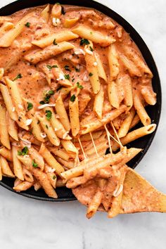 a skillet filled with pasta and sauce