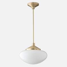 an overhead light fixture with a white glass shade on the bottom and gold metal fittings