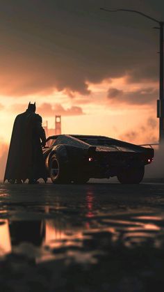 the dark knight batmobile is parked in front of the golden gate bridge as the sun sets