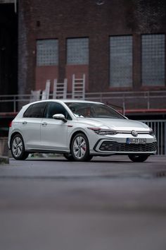 a white car parked in front of a building