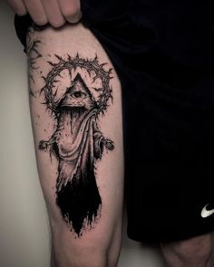 a black and white tattoo on the arm of a man with an all seeing eye