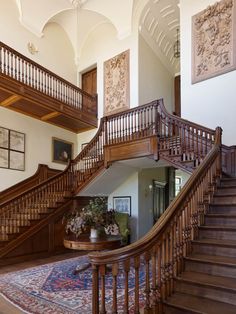 an ornate wooden staircase leading up to the second floor