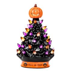 a halloween tree with lights and a jack - o'- lantern in the top