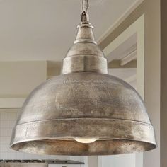 a large metal light hanging from the ceiling