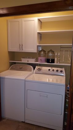 a white washer and dryer sitting next to each other in a laundry room