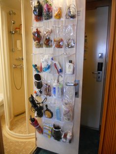 a bathroom with a shower, toilet and shelves filled with personal care items on the wall