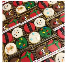 many decorated christmas cookies in boxes on display