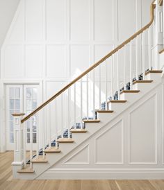 a white staircase with wooden handrails and blue carpeted flooring in an empty room