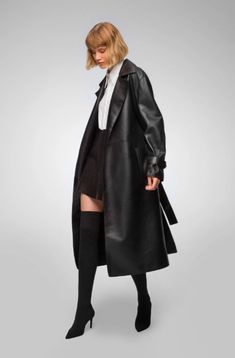 Women's Belted Trench Leather Coat In Black Elevate your wardrobe with this women's belted trench leather coat in black. Made from genuine sheepskin leather with a semi-aniline finish, this coat features a sophisticated turn-down collar and wrap belted closure. The belted waist enhances your silhouette, while open hem cuffs add a refined touch. Practicality meets style with one inside pocket and two side pockets, making this coat a timeless addition to any fashion-forward collection. Outer Shell: Genuine Leather Leather Type: Sheepskin Leather Finish: Semi-aniline Feature: Belted Waist Closure Style: Wrap Belted Collar Style: Turn Down Cuffs Style: Open Hem Inside Pockets: One Outside Pockets: Two Side Pocket Color: Black Leather Shorts Women, Short Leather Skirts, Leather Jumpsuit, Sheepskin Jacket, Shearling Vest, Studded Jacket, Distressed Jacket, Leather Trench, Suede Coat