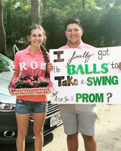 a man and woman holding a sign that says i got the balls to take a swing prom