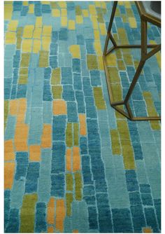 a blue rug with yellow and green squares on it