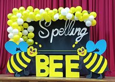 a sign that says spelling bee with balloons around it and two bees on the front