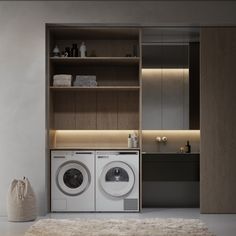 a washer and dryer sitting in front of a wooden shelf filled with towels