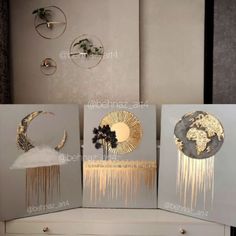 three canvases with gold and silver designs on them, one in the shape of a moon