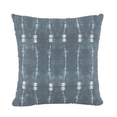 a blue and white pillow on a white background