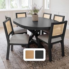 a dining room table with four chairs and a rug