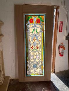 a stained glass door in the corner of a room with a fireplace and fire hydrant