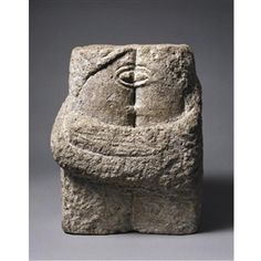 a stone sculpture with a cross on it's head and hands in the center