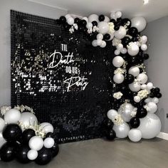 black and white balloons are on display in front of a backdrop that reads,'the date you up party '